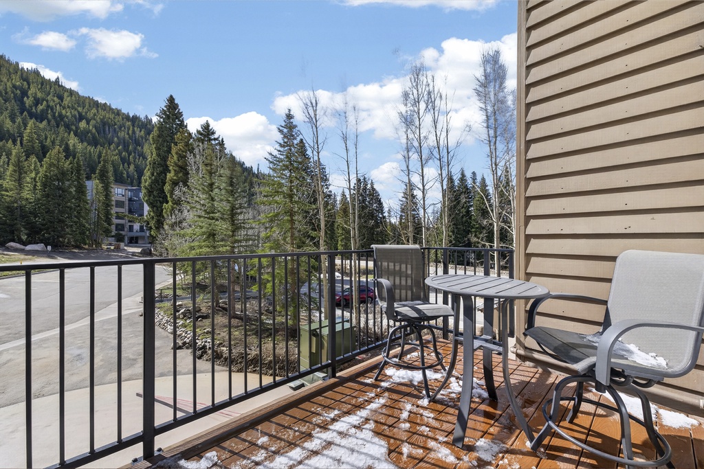 Enjoy morning coffee on your private balcony with mountain and forest views. A small bistro table and chairs create the perfect spot to plan your day's adventures.