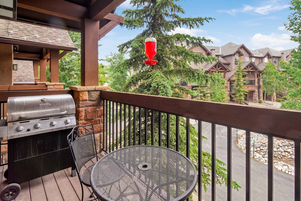 Your private balcony awaits, complete with a gleaming gas grill and cozy seating for alfresco dining. Sip morning coffee or evening wine while soaking in peaceful, tree-lined views.