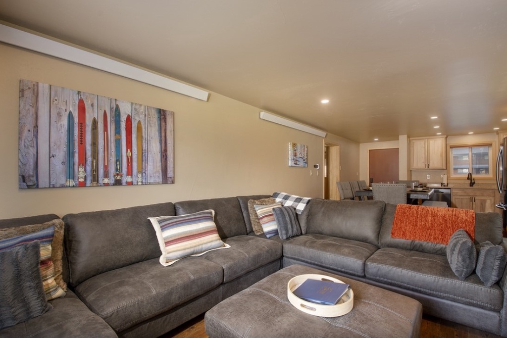 Sink into plush sectional seating where your group can unwind together, with colorful ski artwork creating perfect mountain vibes.