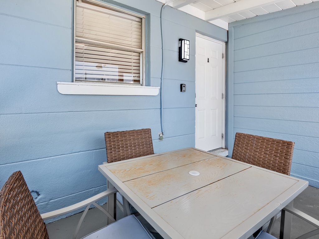 Screened-in lanai with outdoor dining table.
