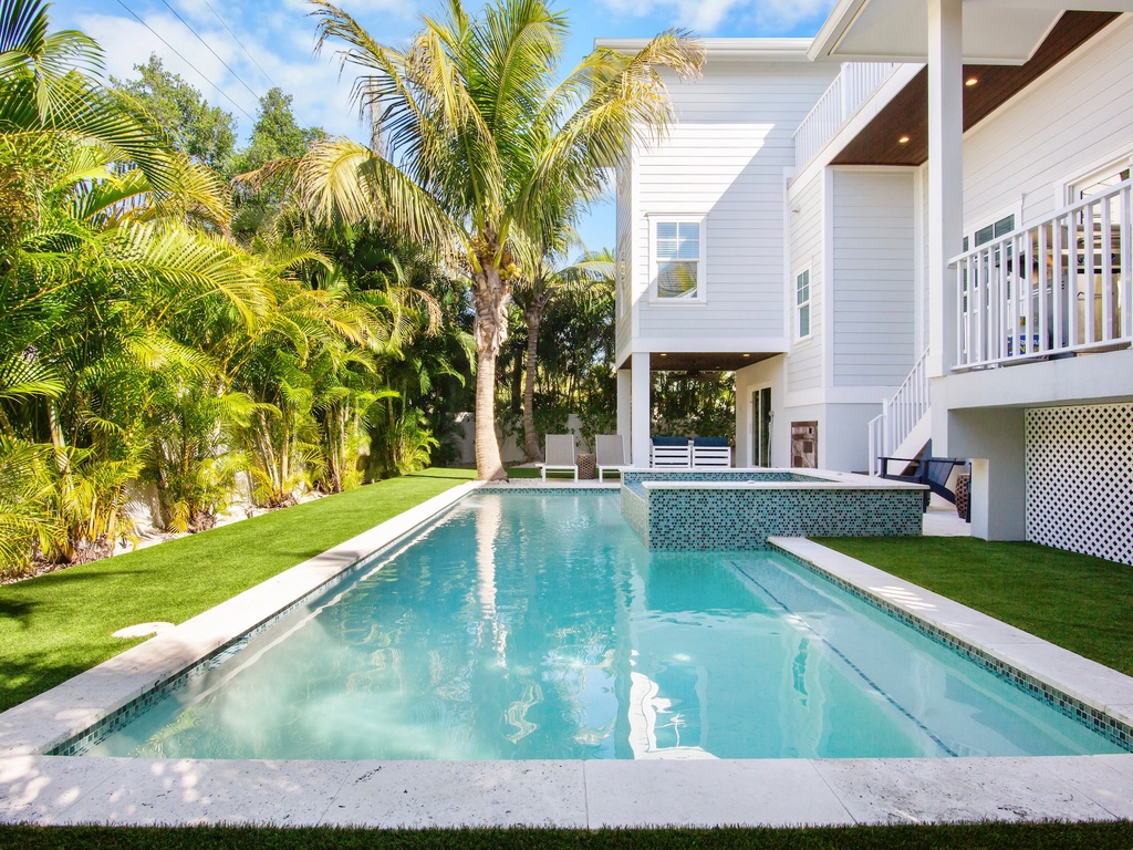 Swimming Pool and Spa surrounded by lush palms