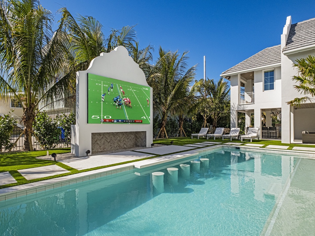 Private pool, swim-up bar seating, and outdoor cinema