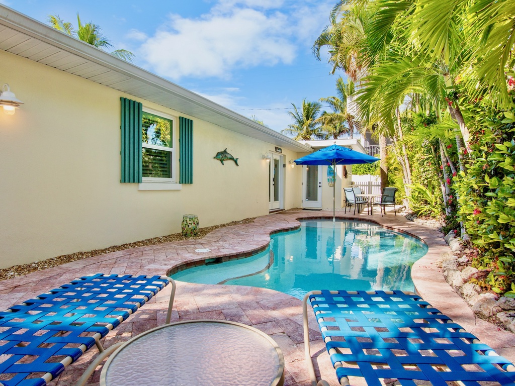 Relax by your private pool surrounded by tropical palms and colorful lounge chairs, with convenient patio dining just steps away from the sparkling water.