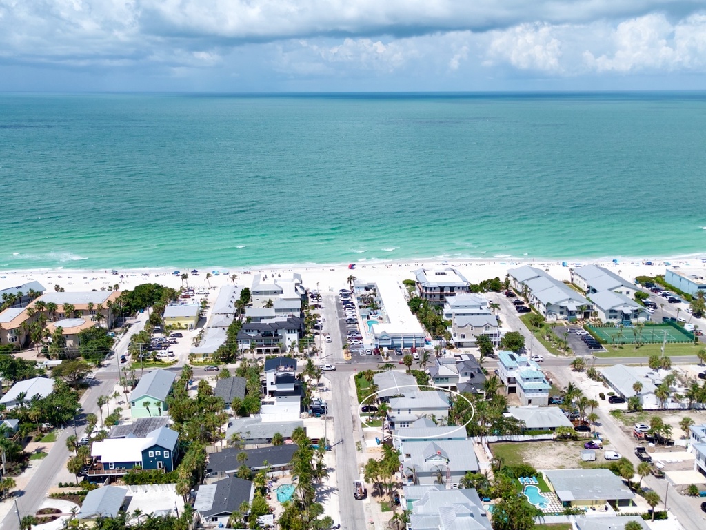 Aerial view showcasing home and beach