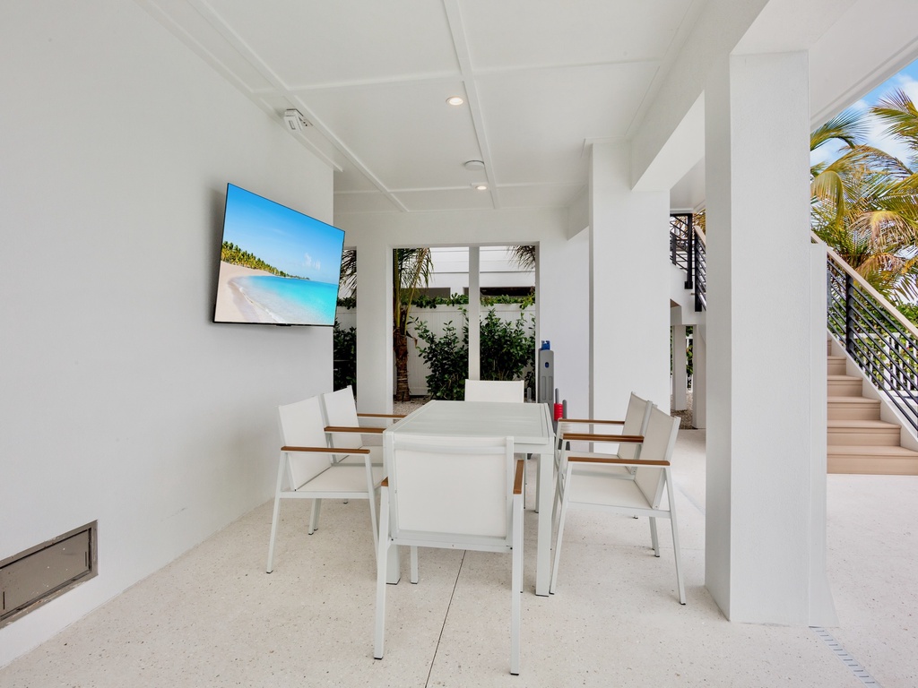 Covered outdoor dining table with TV