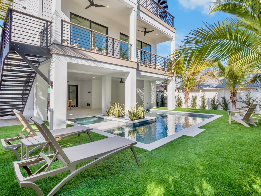 Modern property featuring a stunning swimming pool surrounded by tropical landscaping and contemporary architecture.