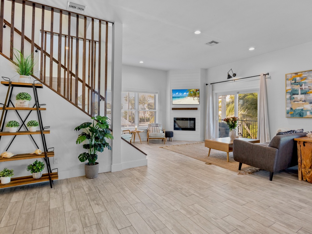Living area with modern fireplace, cozy seating, and TV