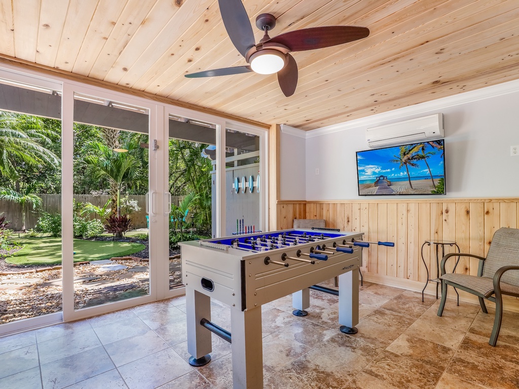 Challenge friends to foosball in your private game room, where tropical garden views and cozy seating create the perfect retreat.