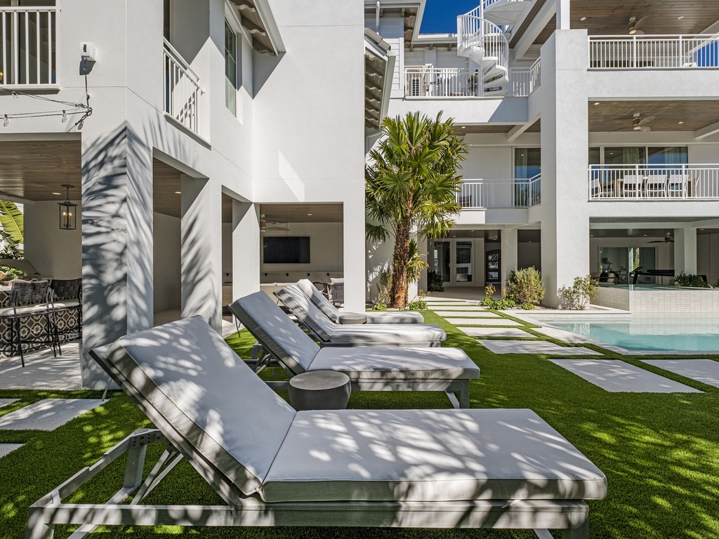 Lounge sunbeds surrounded by lush palms