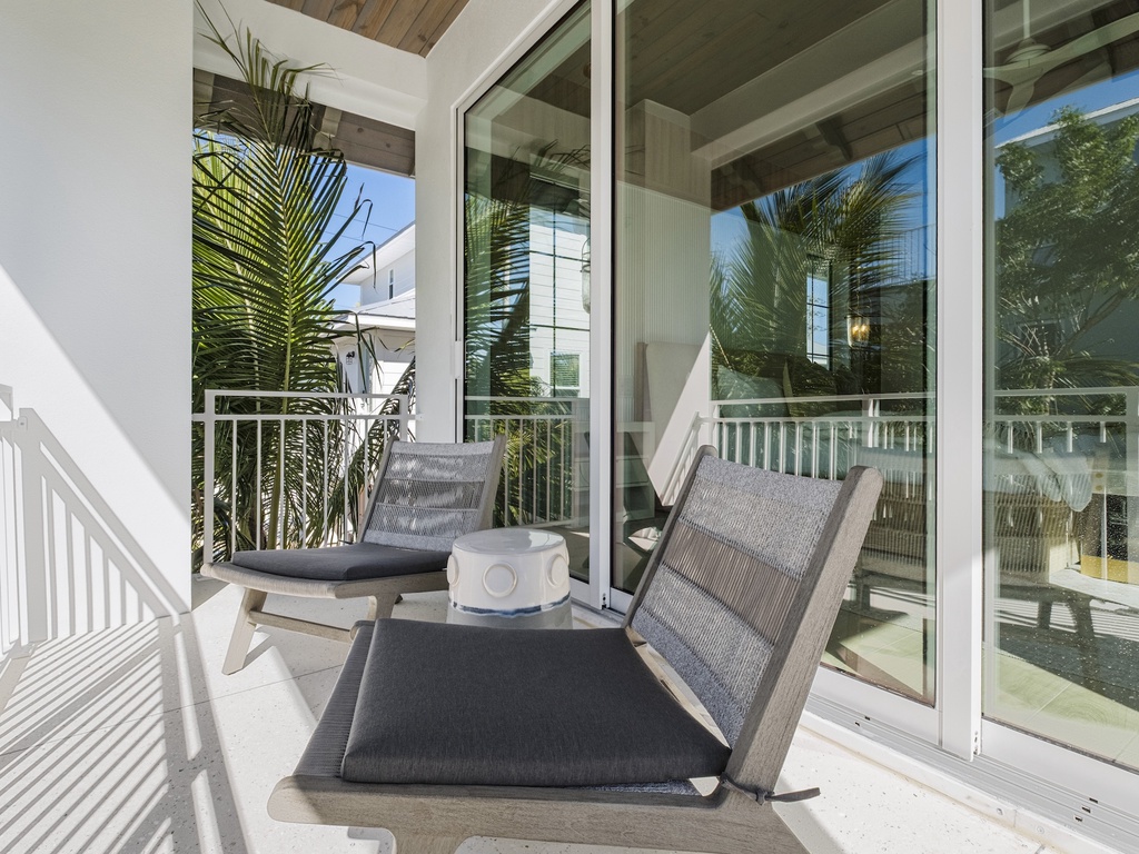 Primary Bedroom, private balcony with lounge chairs