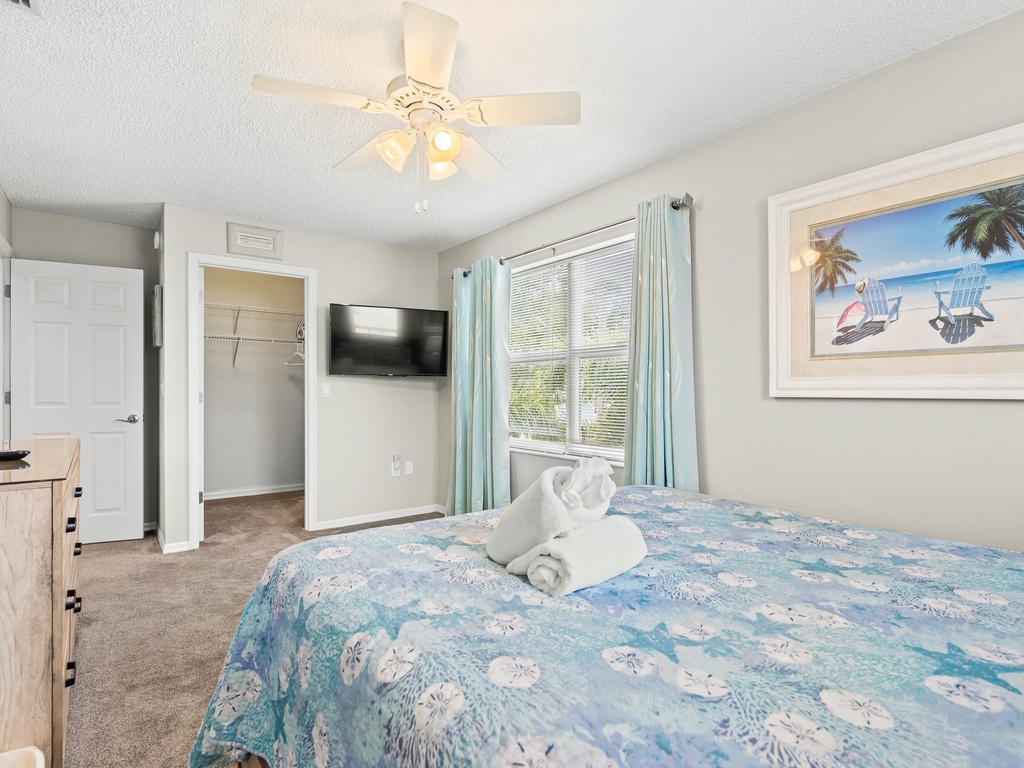 Primary Bedroom with TV and Ceiling Fan