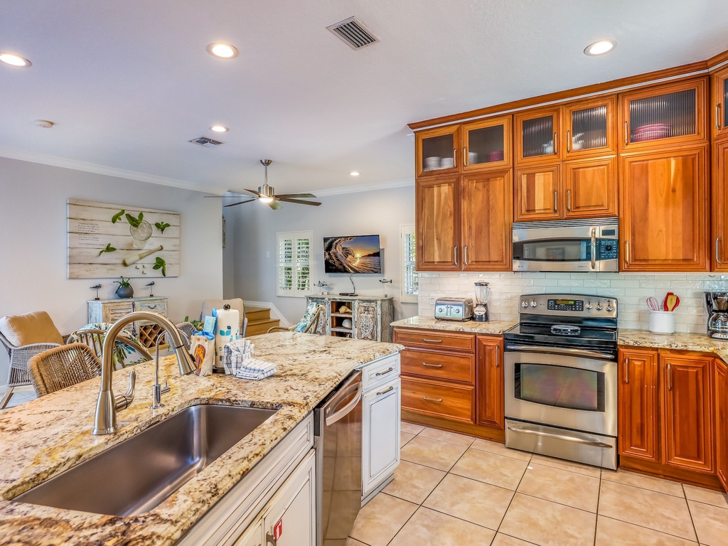 Your gourmet kitchen features granite countertops, rich cherry cabinets, and stainless steel appliances perfect for creating memorable meals together.