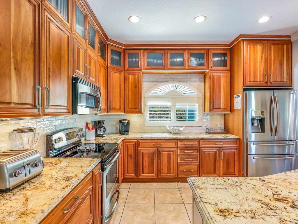 Your gourmet kitchen features rich wood cabinetry, granite countertops, and stainless steel appliances for memorable meal preparation.