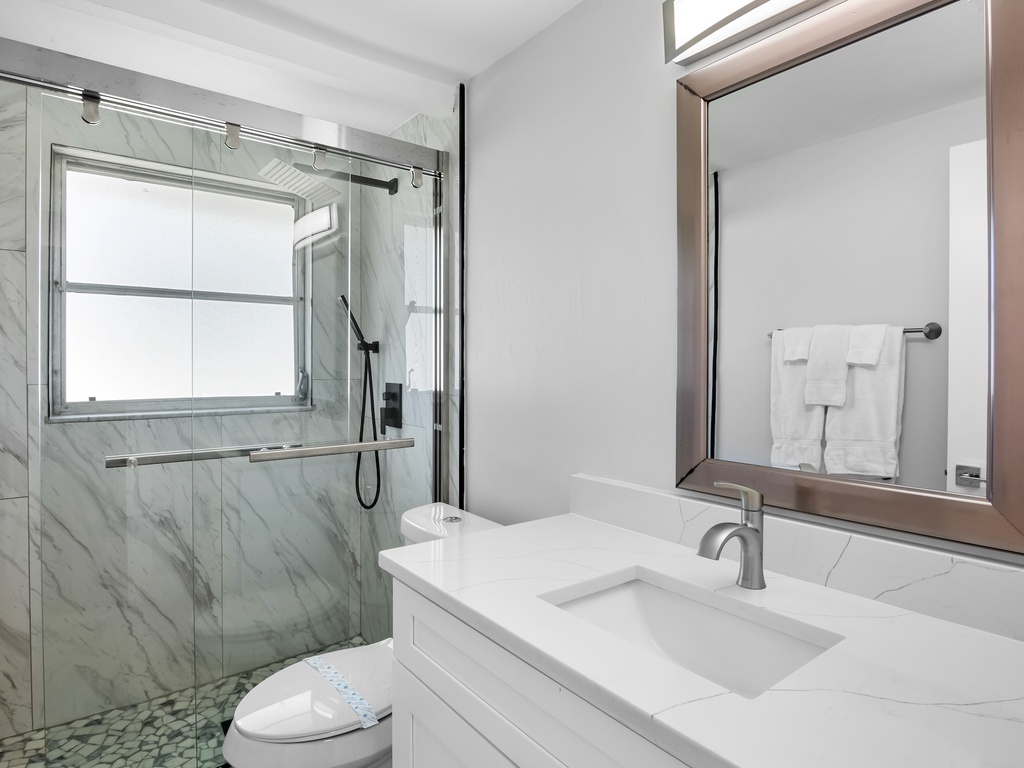 Updated bathroom with modern finishes and walk-in shower.