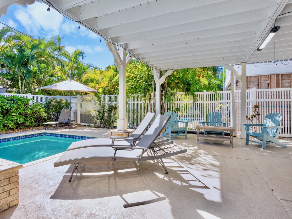 Private covered patio with pool loungers