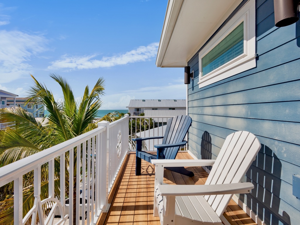 Private balcony with adirondack chairs