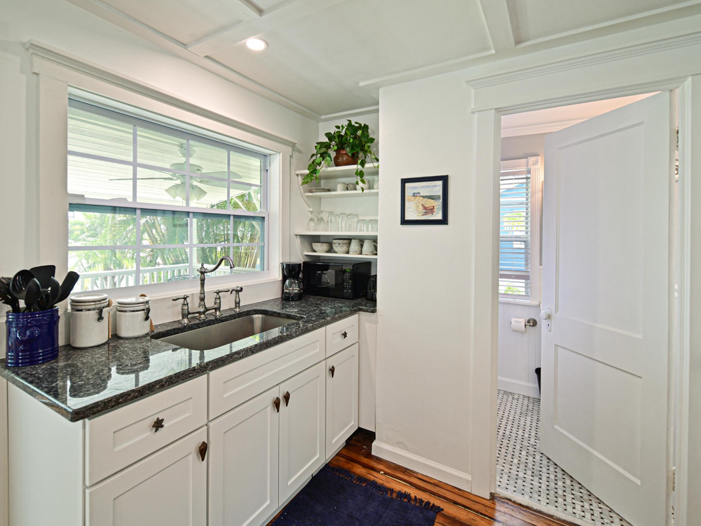 Your bright galley kitchen features granite counters, vintage charm, and garden views—perfect for brewing morning coffee.