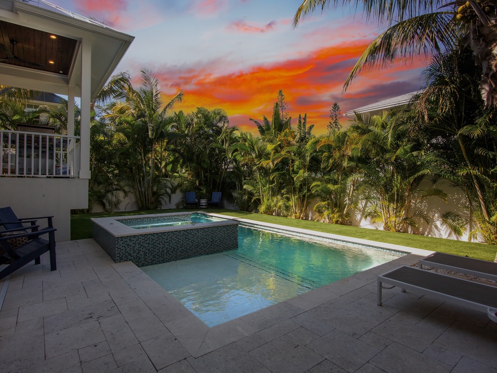 Stunning sunset views with private pool and spa surrounded by lush palms
