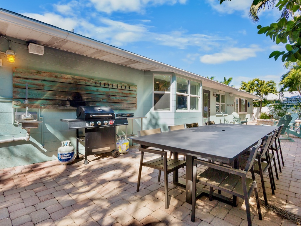 Outdoor dining table with BBQ grill