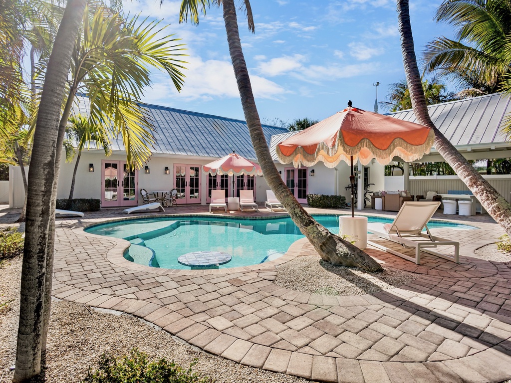 Private tropical oasis and pool surrounded by swaying palms