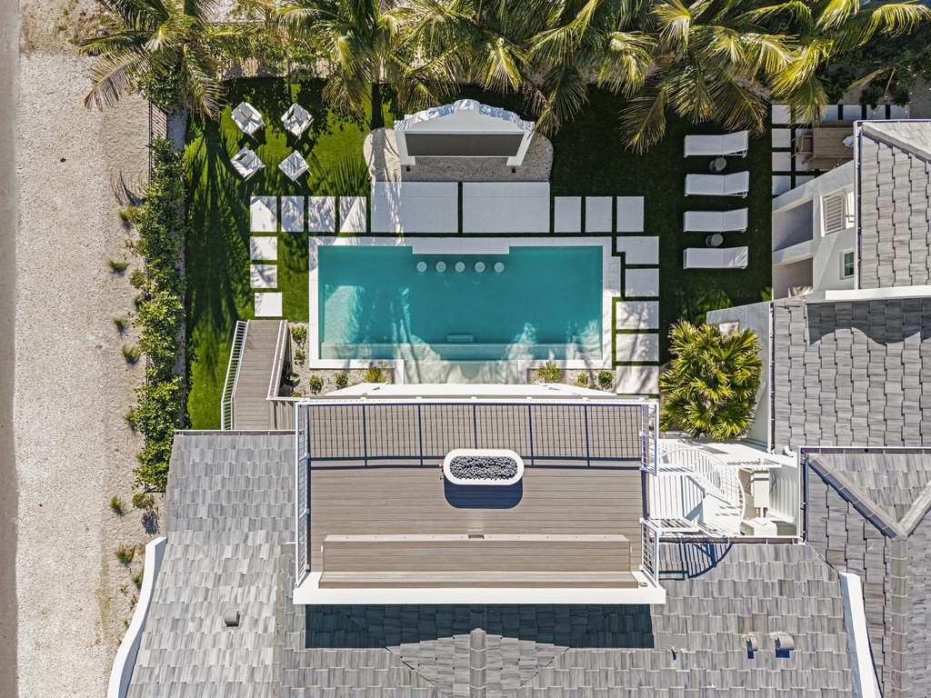 A81A by Exclusive Vacations Anna Maria Island Luxury Retreat -Private pool, spa, and tropical landscaping with palm trees.