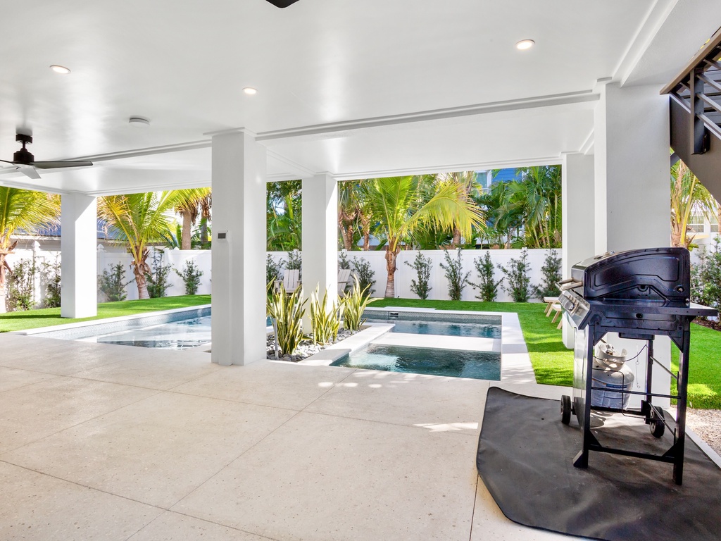 Outdoor oasis with pool, hot tub, and BBQ grill