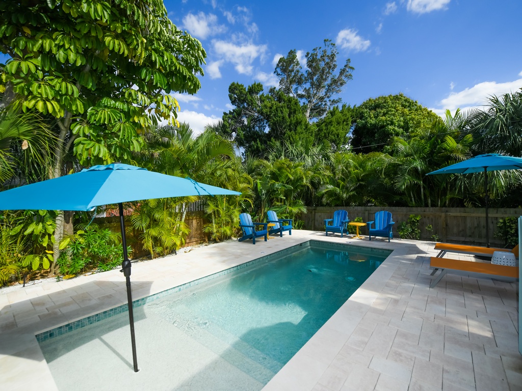 Pool with Umbrella and Lounge Chairs