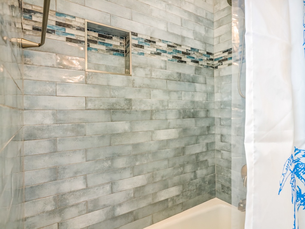 Step into your spa-like shower with stunning tile work and modern fixtures for a refreshing start to your day.