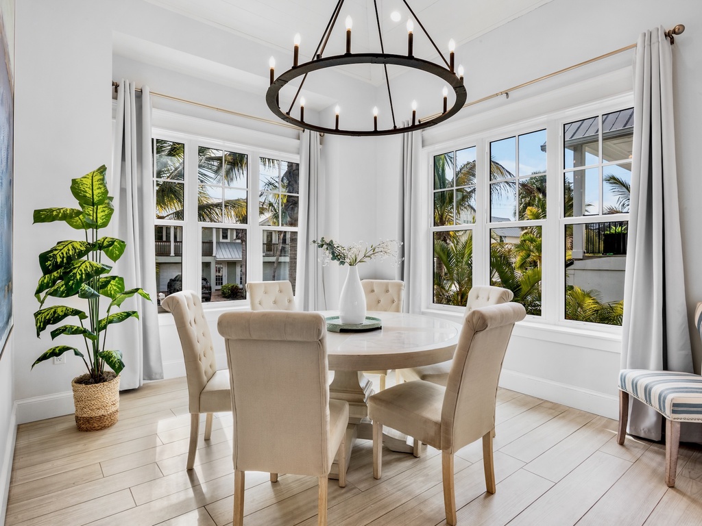 Dining nook with large windows and tropical views