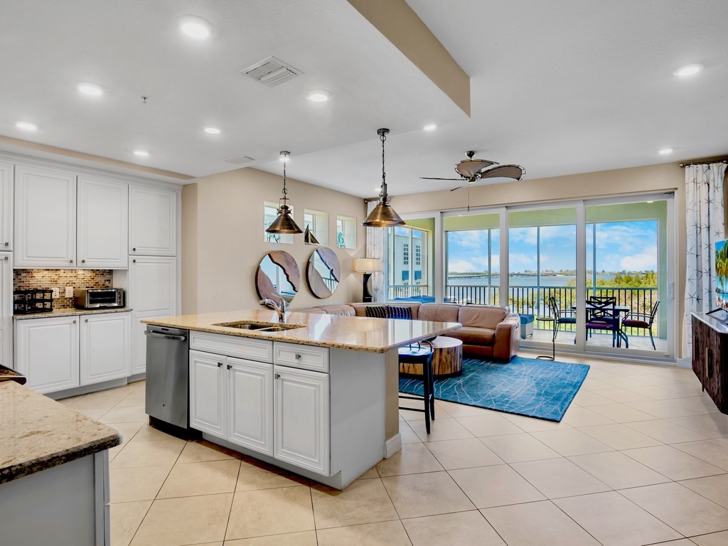Open-concept living area with kitchen island and screened lanai