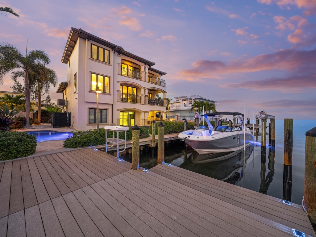 Waterfront luxury home with private dock, pool, and stunning sunset views