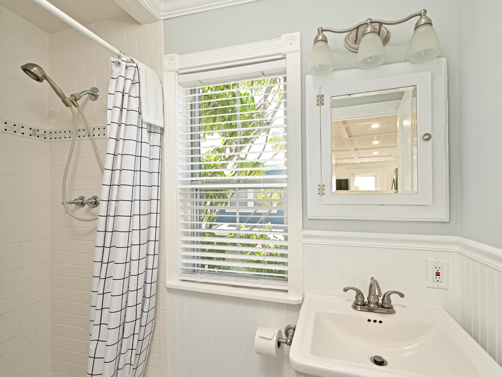 Refresh in your bright, clean bathroom featuring a walk-in shower and classic white finishes that create a spa-like morning routine.