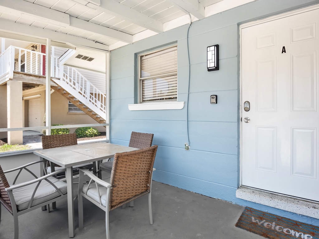 Screened-in lanai with outdoor dining table.