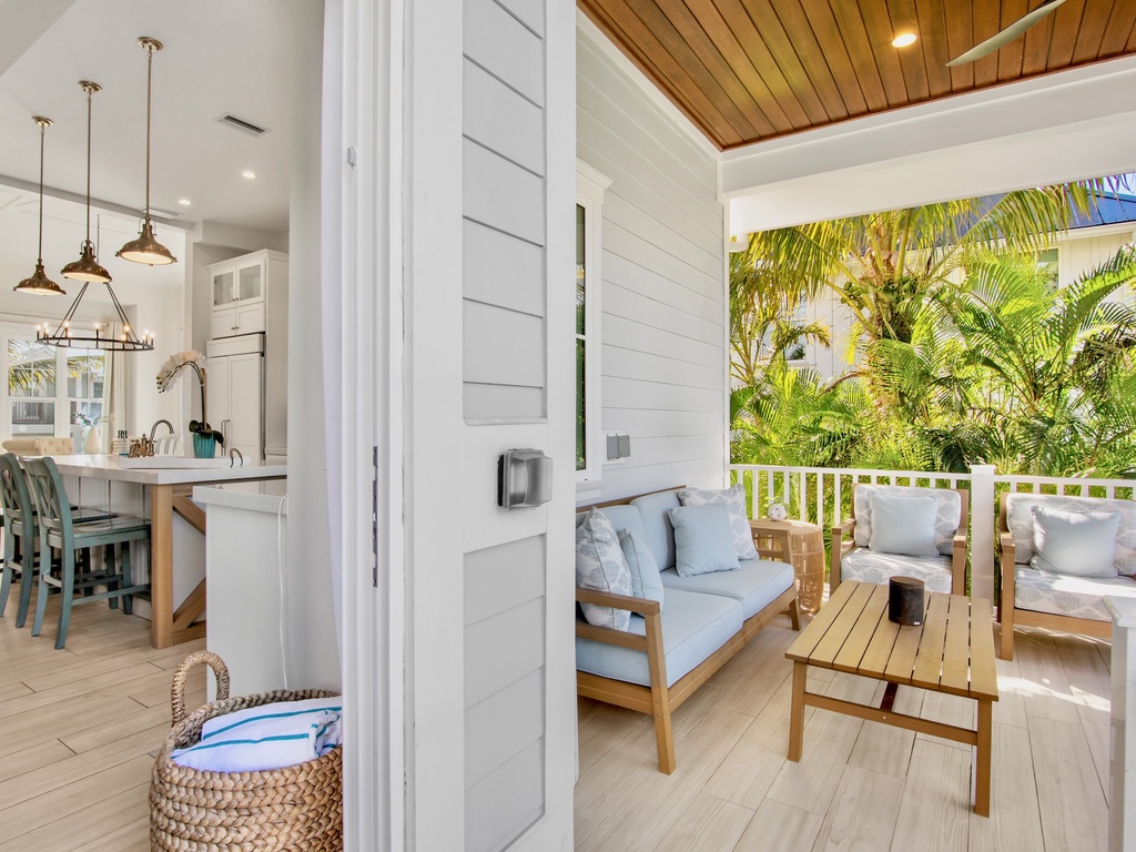 Private covered terrace with seating and BBQ grill