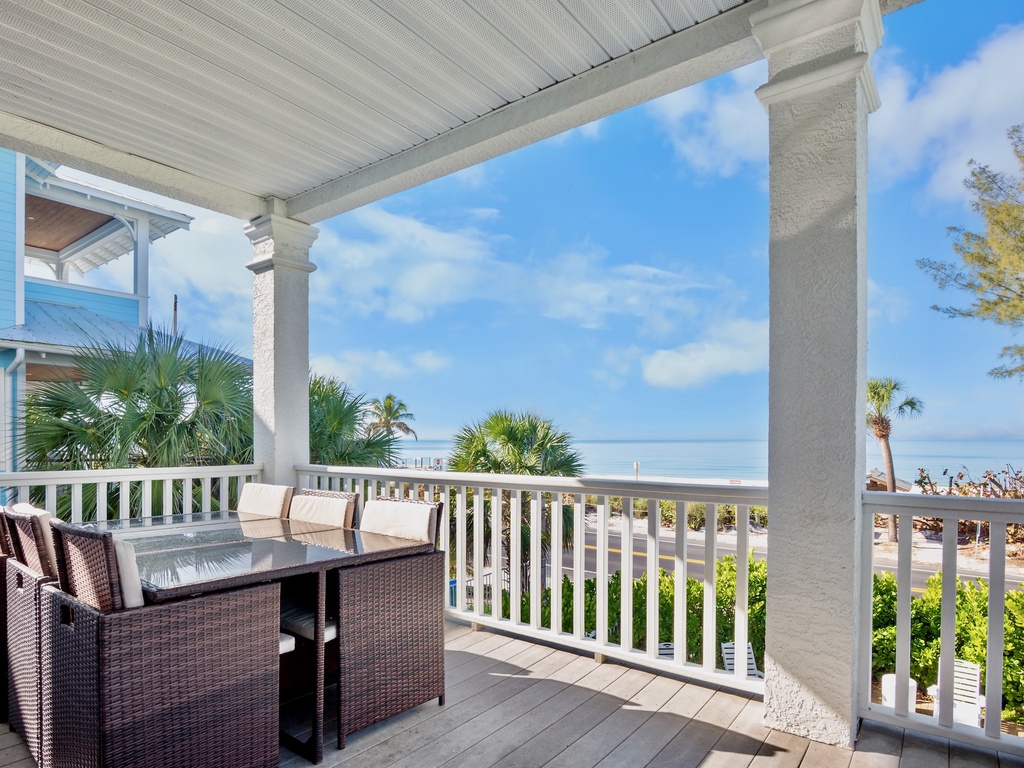 Private covered porch with comfortable dining area