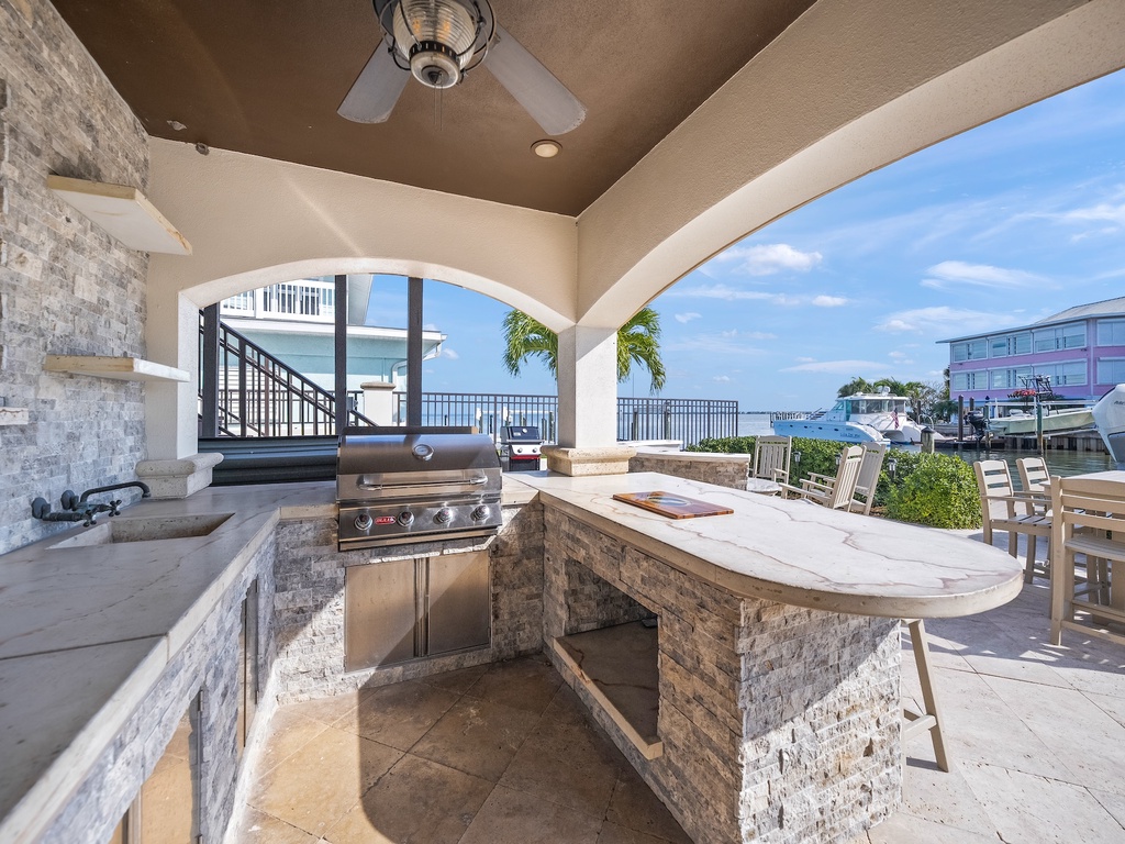 Outdoor kitchen with waterfront views and cooling ceiling fans