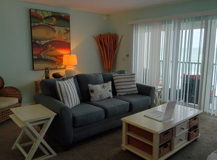 Living room with balcony and beach view