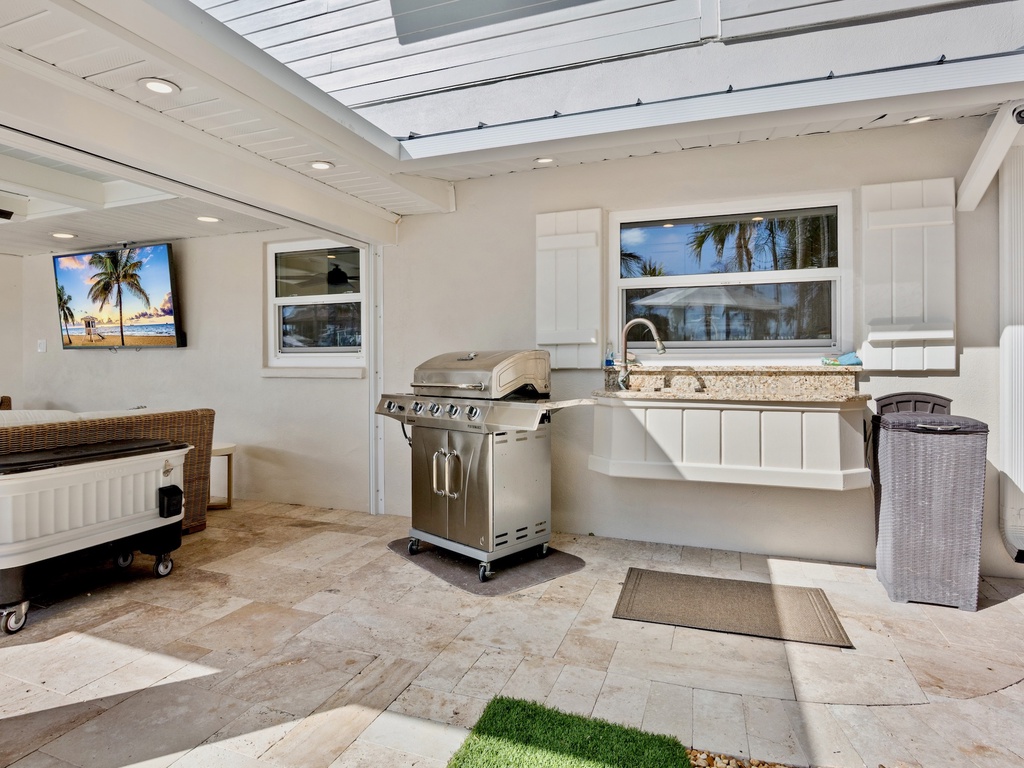 Outdoor kitchen with grill and granite counters