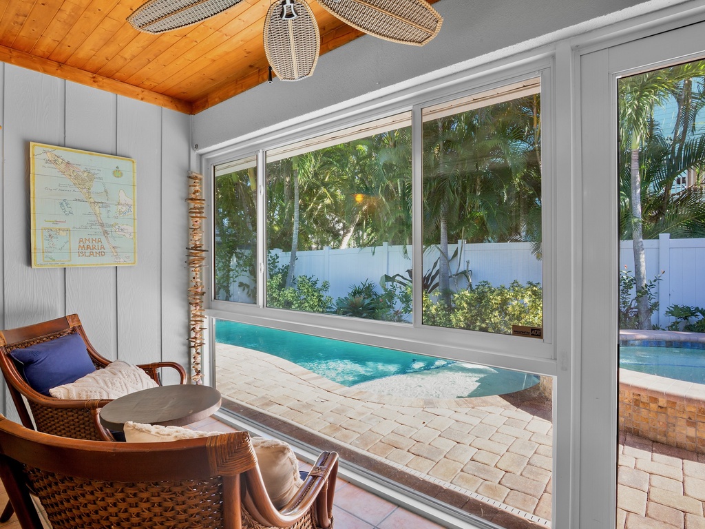 Primary Bedroom with seating and stunning pool views