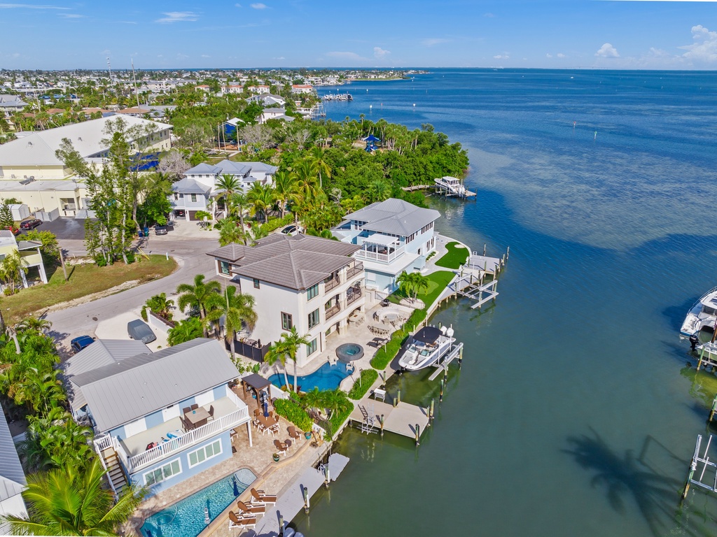 Waterfront villa with direct ocean access, private docks, and sparkling pool overlooking pristine blue waters