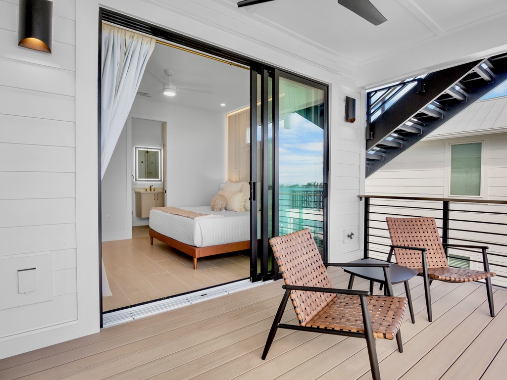 Seamlessly blend indoor comfort with outdoor serenity on your private balcony, where modern furnishings meet stunning water views.