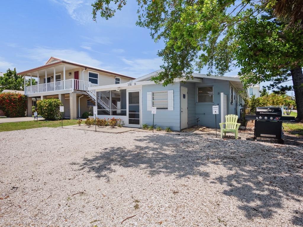 Exterior view of the home with screened lanai and dedicated parking.