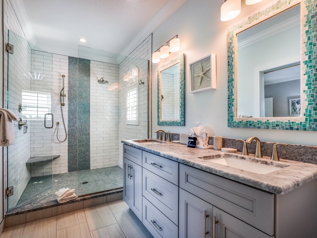 Step into your spa-like bathroom featuring dual vanities, rainfall shower, and stunning coastal-inspired tilework that makes every morning feel luxurious.