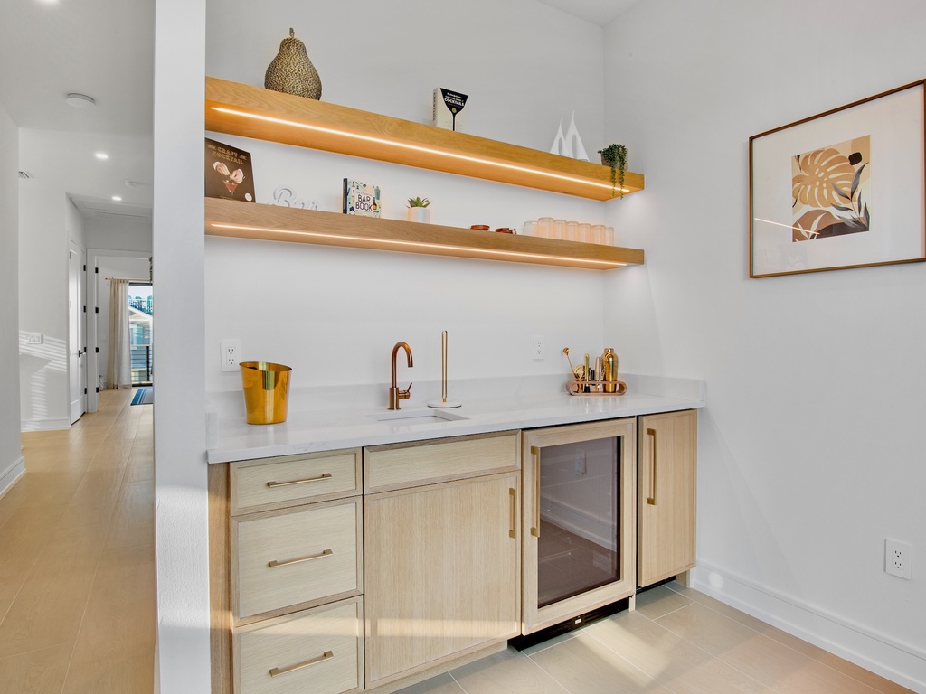 Wet bar with wood cabinets and countertops