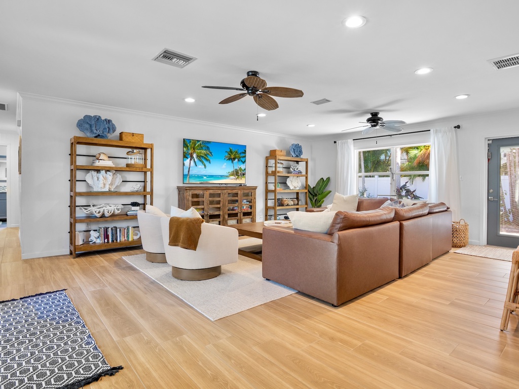 Spacious living area with plush leather seating with TV