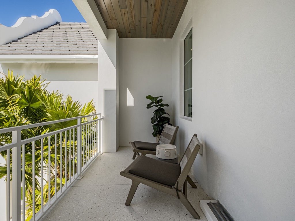 Private balcony with stylish seating and lush tropical views