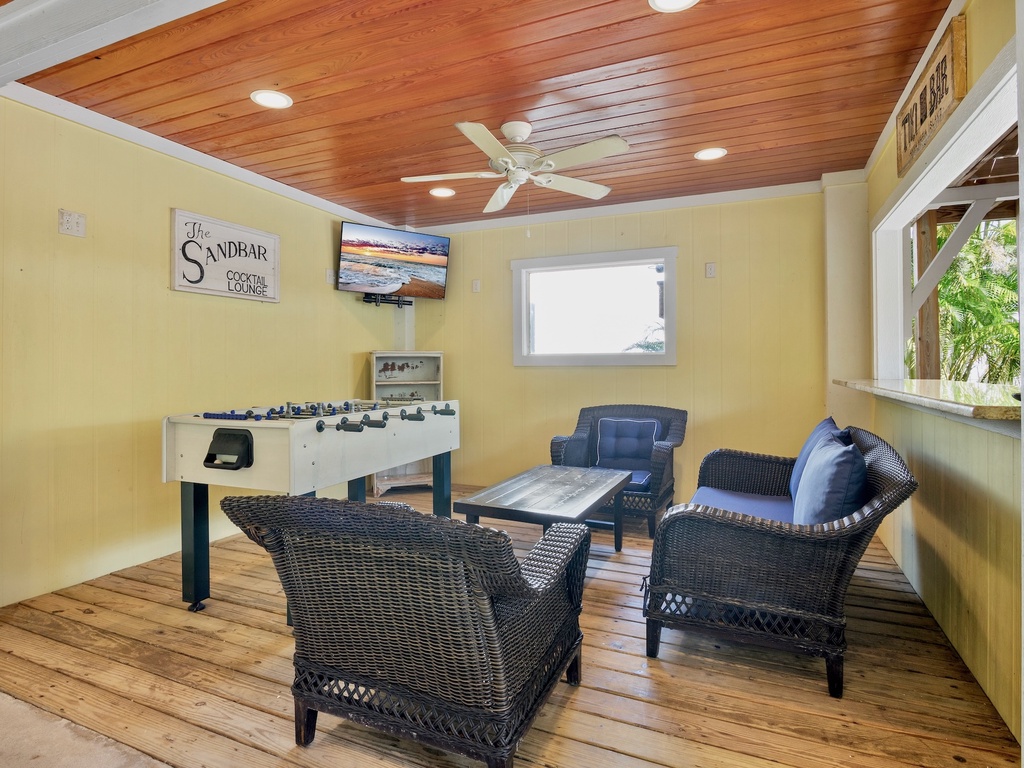 Private game room featuring comfortable seating, foosball table, and TV.