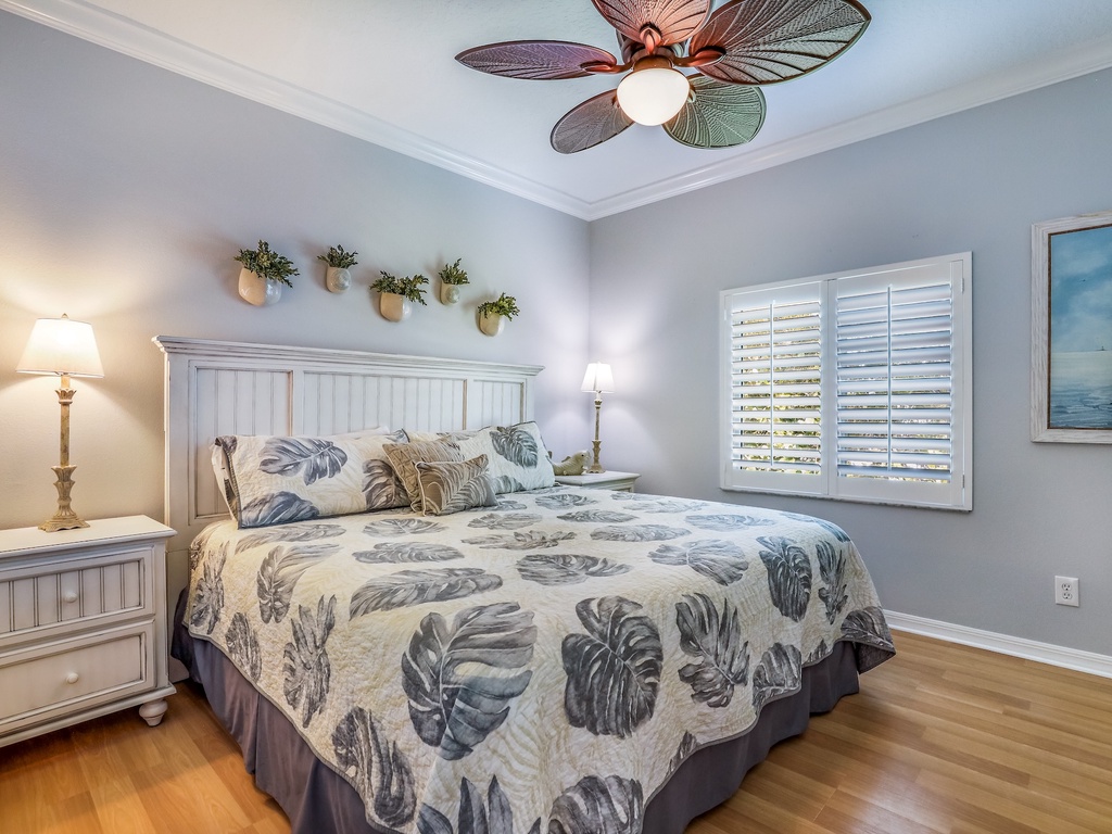Your peaceful bedroom features coastal-inspired decor, tropical bedding, and a charming ceiling fan to keep you comfortable throughout your stay.