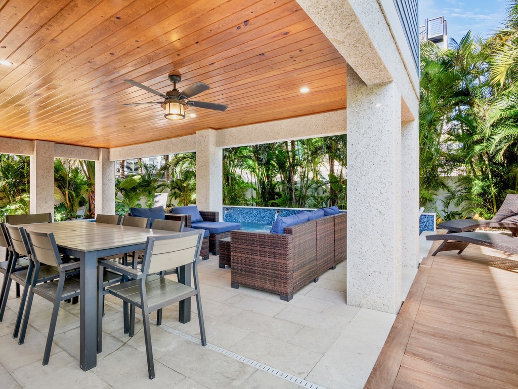Private covered patio with dining space and spa