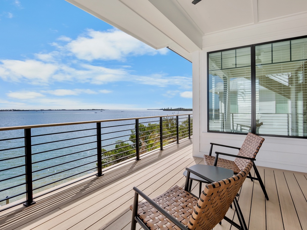 Unwind on your private waterfront balcony with comfortable seating and breathtaking ocean views stretching to the horizon.